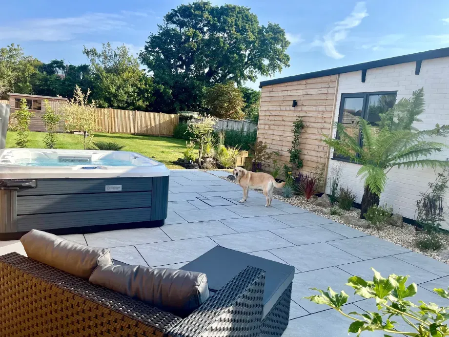 Sunny enclosed garden with hot tub and dog at dog-friendly holiday home in Berrow near Brean